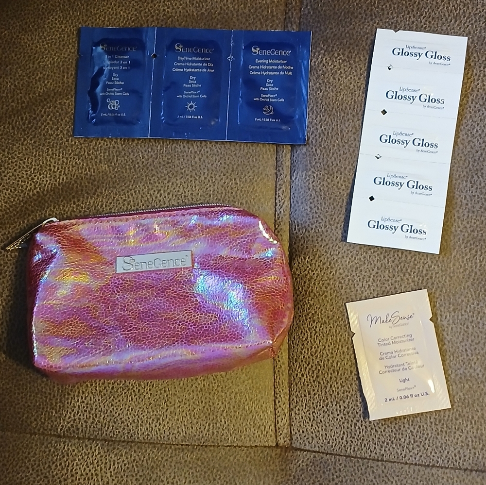 SeneGence pink holographic makeup bag with skin care and gloss samples